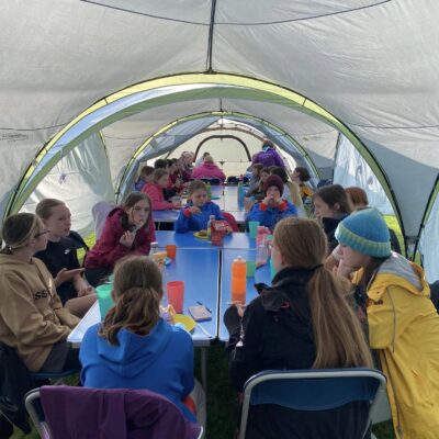 Girls have lunch underneath a shelter