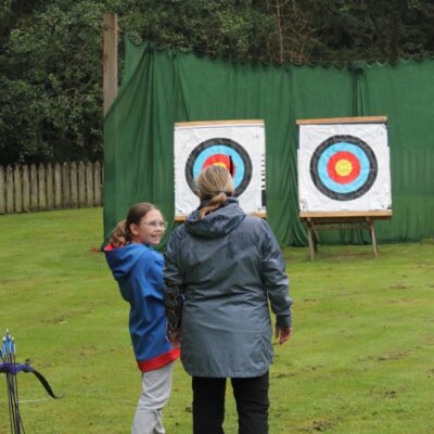 A Guide and leader try archery