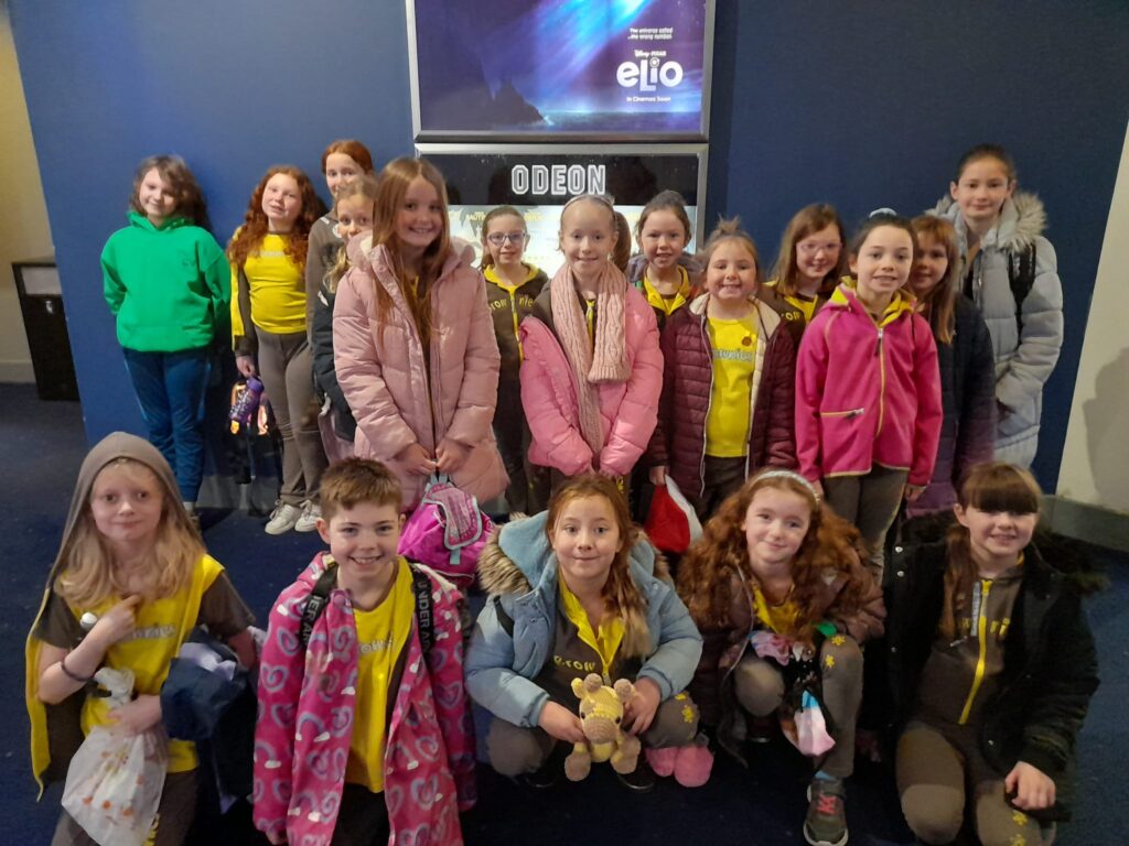 A group of 18 Brownies standing in the foyer of the cinema as a group