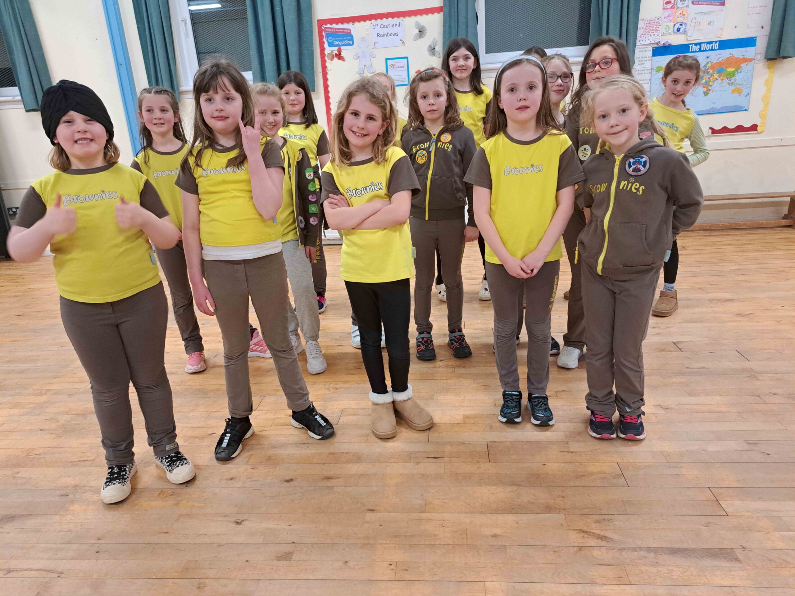 1st Milngavie Brownies standing together looking at the camera and smiling