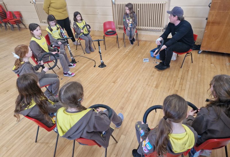 Bike For Good’s Iain Walker shows the girls how to repair a puncture